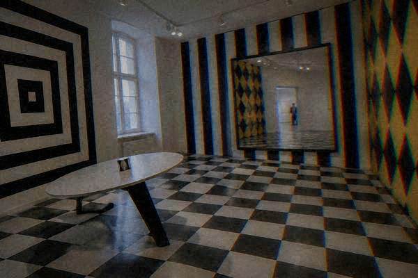 Visitors in a bright illusion room with tilted walls